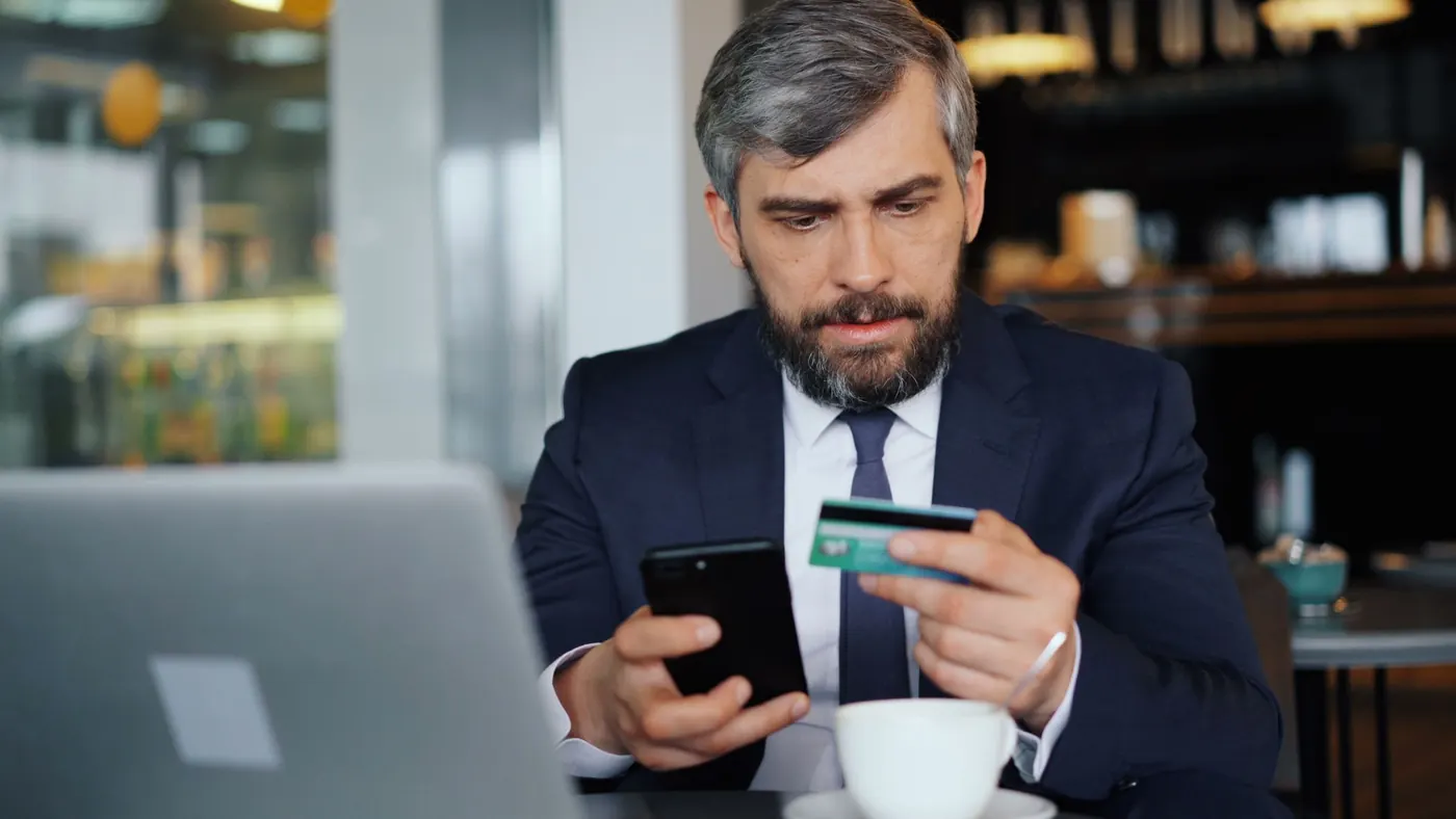 Customer paying with a smartphone and a bank card
