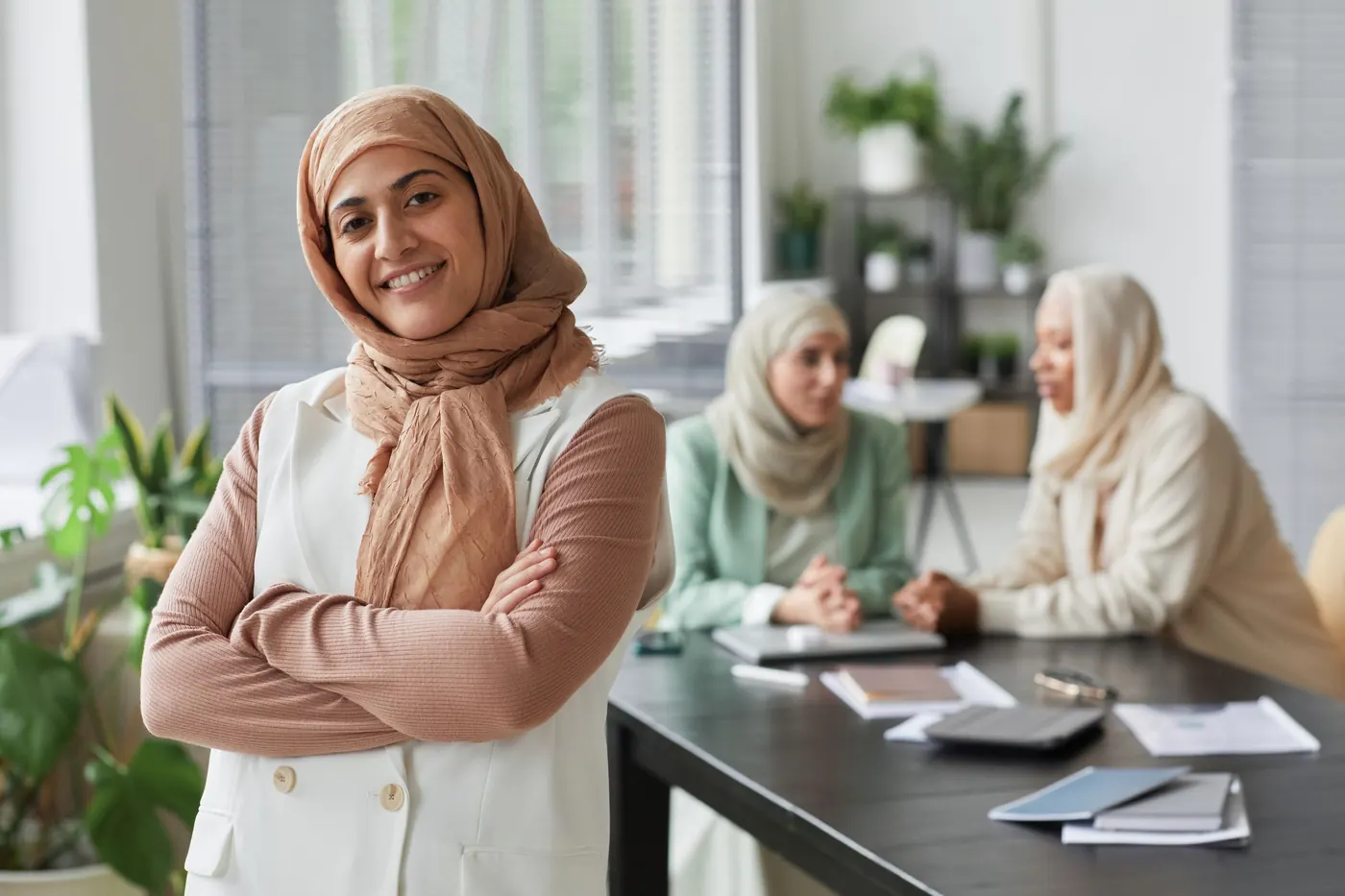 Smiling professional with colleagues in an office