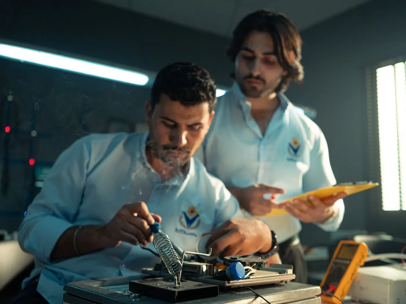 Young engineers working together in an electronics workshop