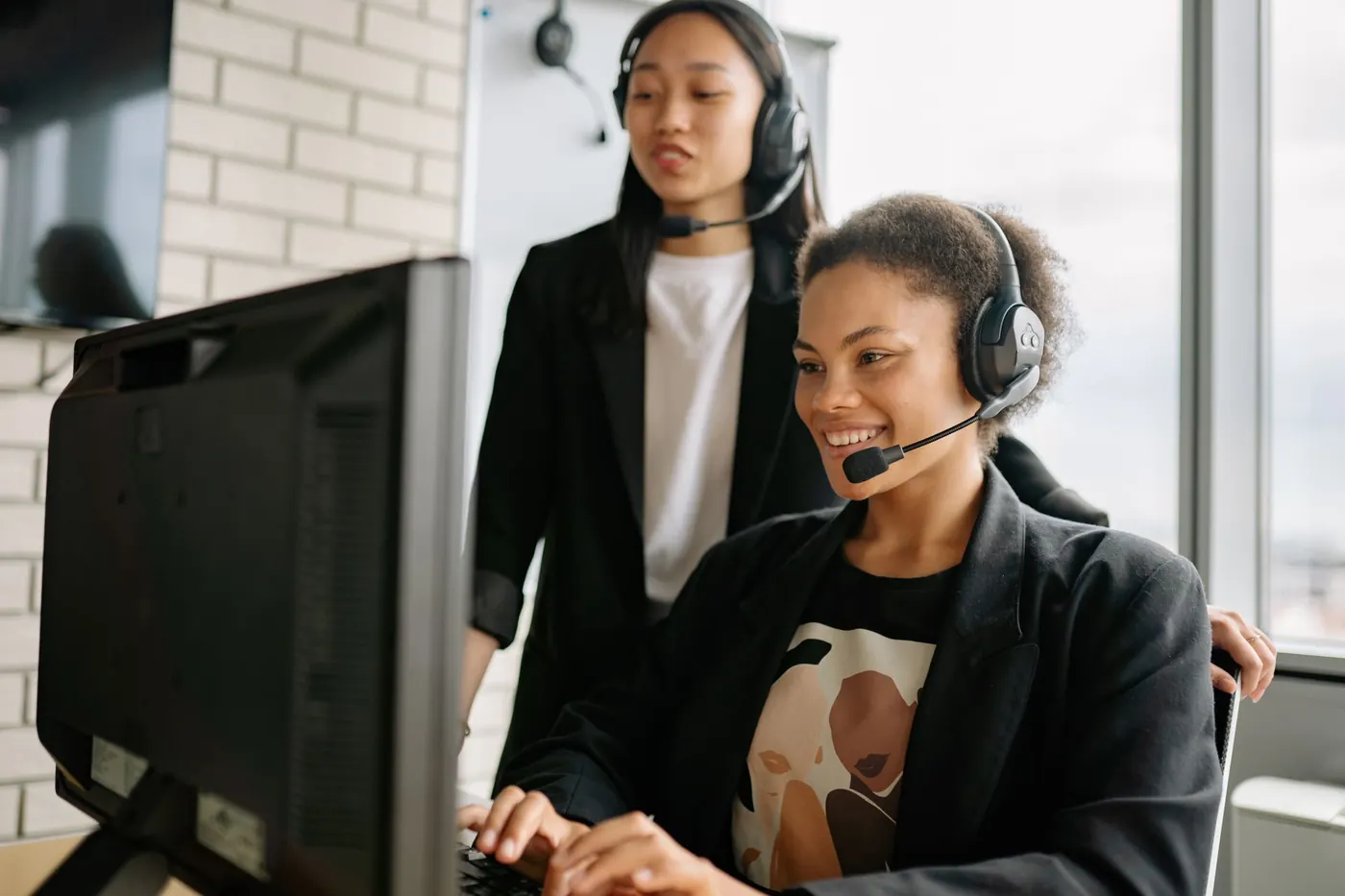 Support specialists with headsets at a workstation