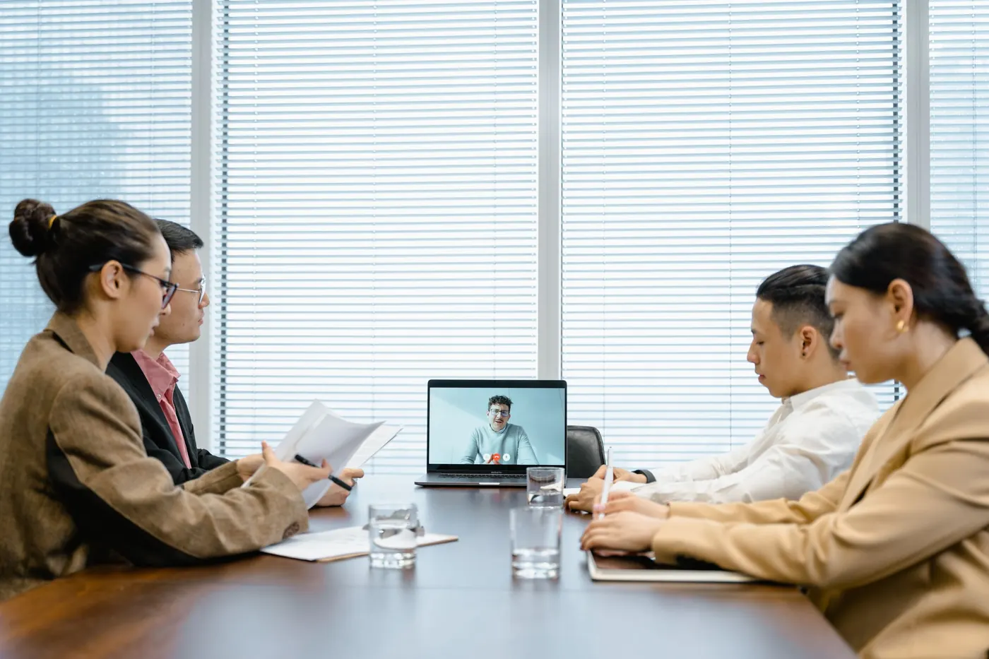 Team meeting with a remote colleague on a video call
